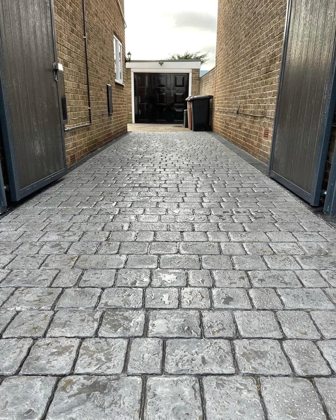 Grey cobble-effect imprinted concrete driveway
