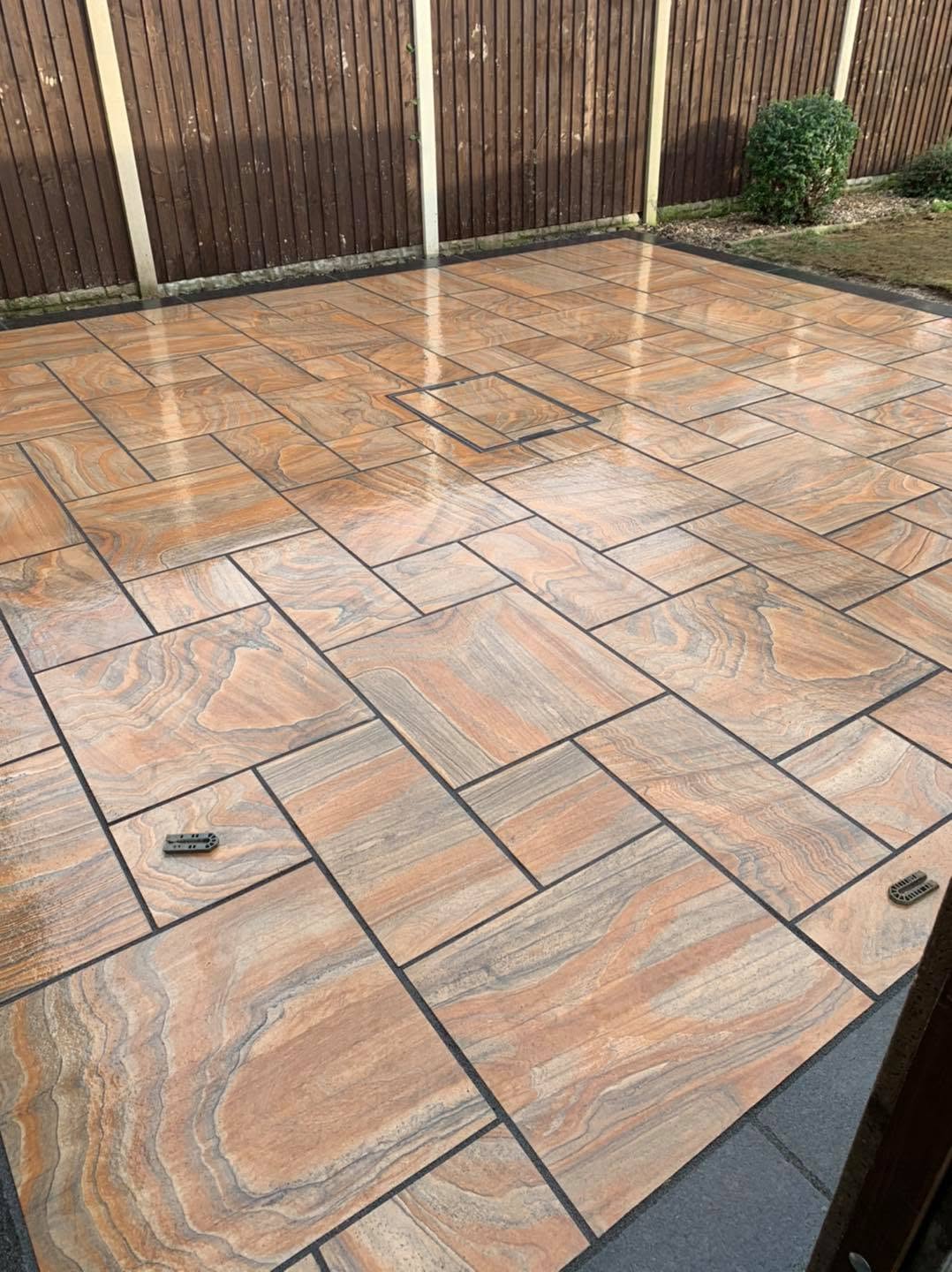 Indian sandstone riven patio with timber fencing