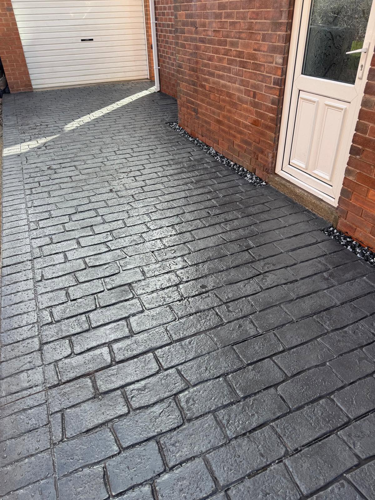 Grey cobble-effect imprinted concrete driveway