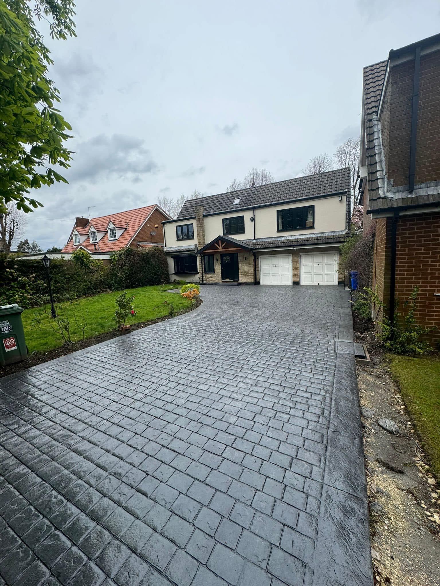 Charcoal imprinted concrete driveway at a detached home