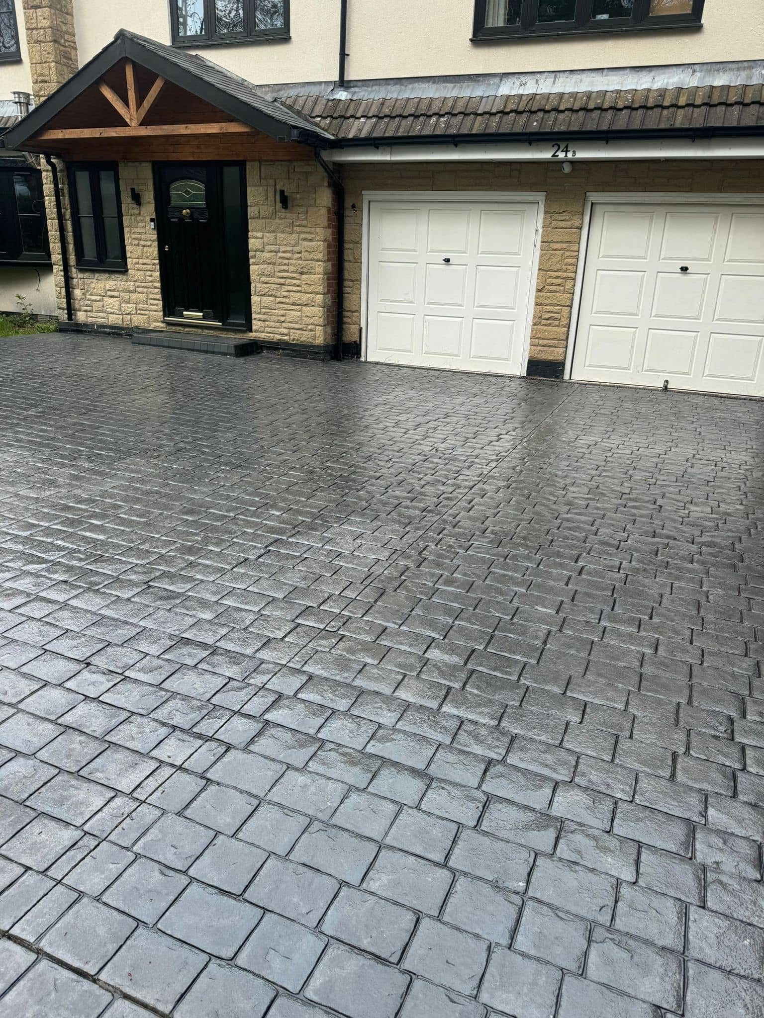 Grey cobblestone imprinted concrete driveway