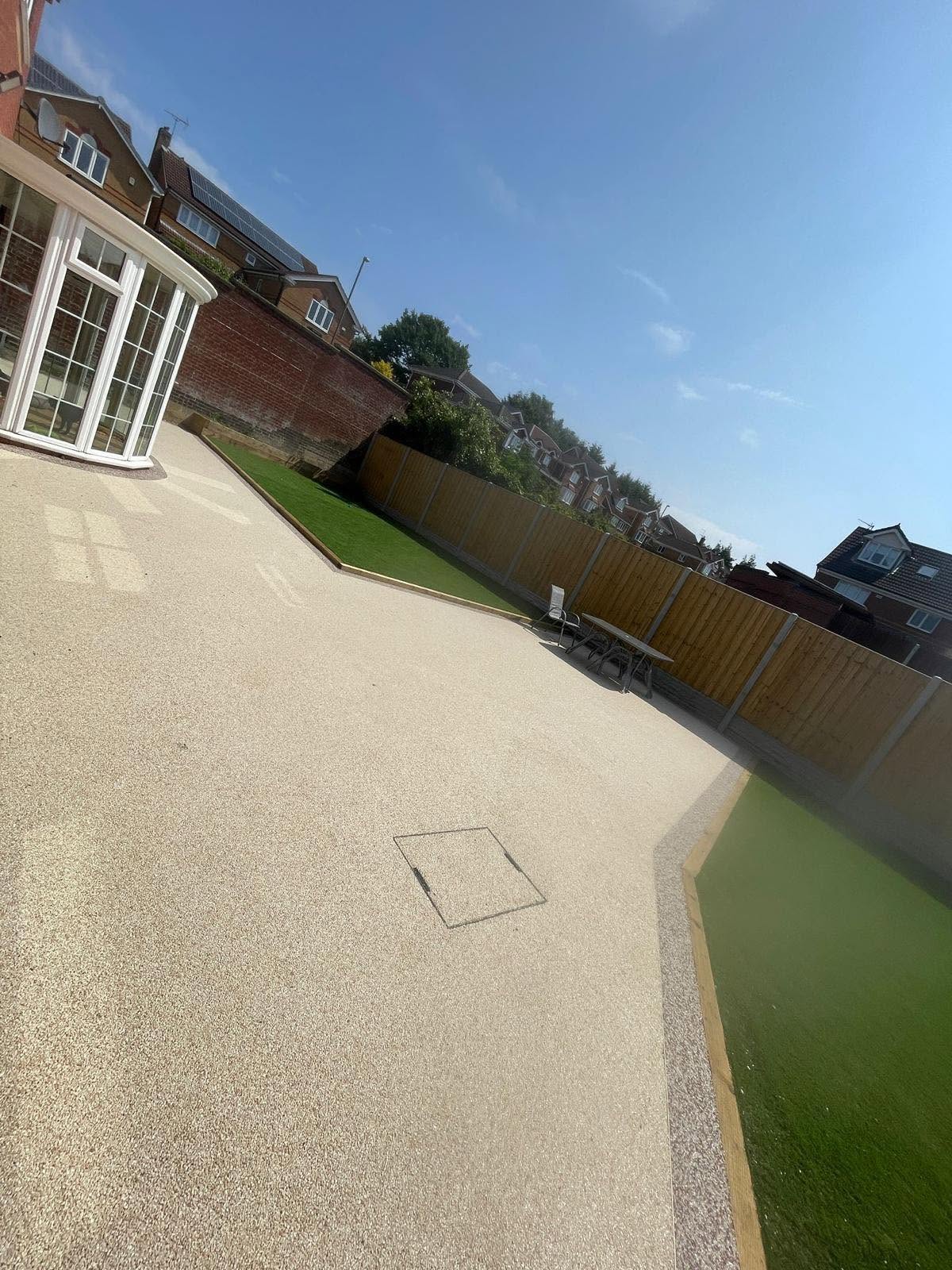 Cream resin-bound driveway with a lawn inset